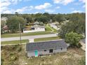 Aerial view of a home showing the backyard and roof with sliding glass doors and trees at 425 Marion Oaks Dr, Ocala, FL 34473