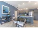 Open-concept dining area with modern furnishings and a view into the stylish kitchen at 463 Kayla Ct, The Villages, FL 32163