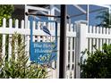 Close-up of Blue Heron Hideaway signage along a white picket fence at 463 Kayla Ct, The Villages, FL 32163