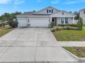 Well-maintained single-story home featuring a three-car garage and spacious driveway at 485 Halter Dr, Apopka, FL 32712