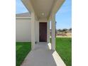 Inviting front porch with supportive columns and a freshly painted front door at 5173 Waypointe Blvd, Apopka, FL 32712