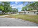 A charming one-story home with an attached garage in a peaceful neighborhood setting at 74 Stone Haven Ct, Leesburg, FL 34788