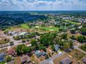 Panoramic aerial shot of the property, showcasing its location near the golf course and surrounding community at 8198 Se 164Th Pl, Summerfield, FL 34491