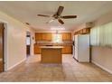 Spacious kitchen showcasing tile flooring, a ceiling fan, a center island and lots of light at 10166 Cr 671, Bushnell, FL 33513