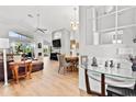 Bright and airy living room with high ceilings, hardwood floors, and large windows allowing ample natural light at 10339 Patrick Dr, Leesburg, FL 34788