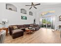 Open-concept living room with a sliding glass door to the patio and comfortable seating at 10339 Patrick Dr, Leesburg, FL 34788