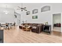 Spacious living room with vaulted ceilings, recessed lighting, and a plush leather sectional at 10339 Patrick Dr, Leesburg, FL 34788