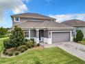 Elegant two-story home showcasing a landscaped front yard, neutral color scheme, and a two-car garage at 1051 Nathan Ridge Rd, Clermont, FL 34715