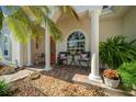 Charming front porch with brick pavers, rocking chairs, and lush landscaping at 11860 Se 179Th St, Summerfield, FL 34491