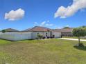 Charming single-story home featuring a well-maintained lawn, fenced yard, and beautifully landscaped flower beds at 11995 Callicarpa Ln, Leesburg, FL 34788