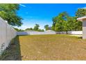 Expansive backyard featuring a well-maintained lawn, a white fence, and plenty of room for outdoor activities at 12150 Se 88Th Ct, Belleview, FL 34420