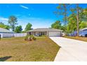 Well-maintained single-Gathering home with a spacious driveway, a two-car garage, and a manicured lawn at 12150 Se 88Th Ct, Belleview, FL 34420