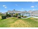 Inviting single-story home featuring a well-kept lawn and an attached two-car garage at 1306 Pedro Ct, The Villages, FL 32159
