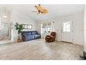 Spacious living room featuring light wood-look tile floors and bright, natural light at 1306 Pedro Ct, The Villages, FL 32159