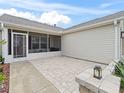 View of a covered patio with brick flooring and privacy screen at 1307 Galindo Pl, The Villages, FL 32159