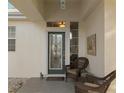Inviting front porch area featuring a charming seating arrangement and a decorative mosaic artwork on the exterior wall at 13190 Se 93Rd Cir, Summerfield, FL 34491