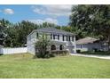 Lovely two-story home featuring lush green lawn and a side view of its exterior at 1704 Hoofprint Court, Fruitland Park, FL 34731