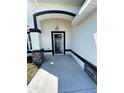 Inviting entryway highlighting stone pillars and a modern, arched doorway design at 17459 Sw 17Th Cir, Ocala, FL 34473