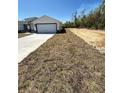 New home featuring a large front yard and spacious driveway leading to the garage at 17459 Sw 17Th Cir, Ocala, FL 34473