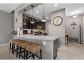 Kitchen with granite countertops, dark wood cabinets, stainless appliances, and barstool seating at the island at 17519 Promenade Dr, Clermont, FL 34711