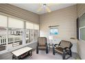 Enclosed sun room with comfortable seating, ceiling fan, and bright natural light at 1833 Endsley Ct, The Villages, FL 32162