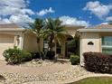Inviting front entrance with decorative stone pathway and lush landscaping at 2071 Westchester Way, The Villages, FL 32162