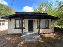 Single-story home, a covered front porch with support columns, and painted white brick at 2107 Hollywood Ave, Eustis, FL 32726