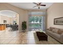 Bright living room featuring tile floors, neutral walls, and sliding glass doors to the outdoors at 223 Crepe Myrtle Dr, Groveland, FL 34736
