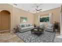 Comfortable living room with neutral furniture, tile floors, and a large window for natural light at 223 Crepe Myrtle Dr, Groveland, FL 34736