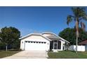 Attractive single-story home boasts a well-maintained lawn and attached two-car garage at 223 Lady Diana Dr, Davenport, FL 33837