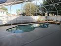 Relaxing in-ground pool surrounded by a screened enclosure for ultimate privacy and enjoyment at 223 Lady Diana Dr, Davenport, FL 33837
