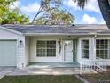 Close-up of the home's front facade, showcasing the entrance and attached garage at 25540 Belle Helene, Leesburg, FL 34748