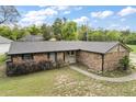 Charming brick home featuring a well-maintained lawn and inviting curb appeal with mature trees and plantings at 30641 County Road 435, Sorrento, FL 32776