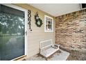 Inviting front porch with white bench, wreath, exterior lighting, and house number display at 30641 County Road 435, Sorrento, FL 32776