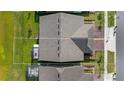 Aerial view of home with brown roof and driveway outlined with white line at 3256 Canna Lily Pl, Clermont, FL 34711