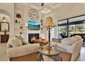 Comfortable living room with fireplace, built-in shelves, and sliding glass doors to the outdoor patio at 39705 Grove Hts, Lady Lake, FL 32159