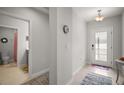 Inviting foyer with neutral walls, tiled floors, and a view of the bathroom at 444 Shadow Gorge Way, Eustis, FL 32736