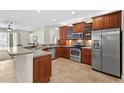A modern kitchen features stainless steel appliances and ample counter space at 5138 Rishley Run Way, Mount Dora, FL 32757