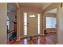 Welcoming entryway with hardwood floors and decorative glass sidelights at 5408 Queen Victoria Dr, Leesburg, FL 34748
