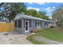 Inviting home exterior showcasing a screened-in front porch and well-maintained yard at 602 Ross St, Leesburg, FL 34748