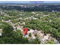 Expansive aerial view showcases property location near Downtown Deland, enveloped by lush greenery and neighborhood streets at 726 S Stone St, Deland, FL 32720