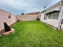 A charming backyard features a well-maintained lawn and privacy fence, creating a relaxing outdoor space at 728 Ramirez Ave, The Villages, FL 32159