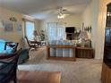 Bright living room with plush carpeting, vaulted ceilings, and sliding glass doors to the outdoor space at 728 Ramirez Ave, The Villages, FL 32159