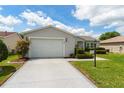 Charming single-story home with well-maintained landscaping and an attached garage at 870 Danforth Ct, The Villages, FL 32162