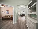 Inviting foyer with hardwood floors and ample natural light flowing into the living spaces at 879 Lucky Ln, The Villages, FL 32162