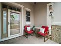 Cozy covered front porch with seating, perfect for relaxing and enjoying the outdoors at 879 Lucky Ln, The Villages, FL 32162