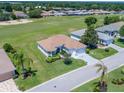 An aerial view of a home with beautiful landscaping and a golf course view at 11702 Se 173Rd Lane Rd, Summerfield, FL 34491