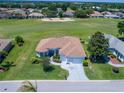 Charming home with a well-maintained lawn, landscaping and a view of the golf course at 11702 Se 173Rd Lane Rd, Summerfield, FL 34491