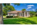 Charming home featuring a manicured lawn, and a covered entrance for added curb appeal at 11811 Ridge View Cir, Clermont, FL 34711