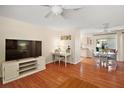Open-concept living room with hardwood floors and ample natural light at 1203 Zapata Pl, The Villages, FL 32159